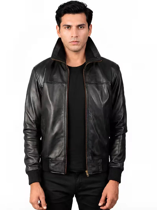 Man wearing a black sheepskin leather bomber jacket with stand collar showing a regular fit